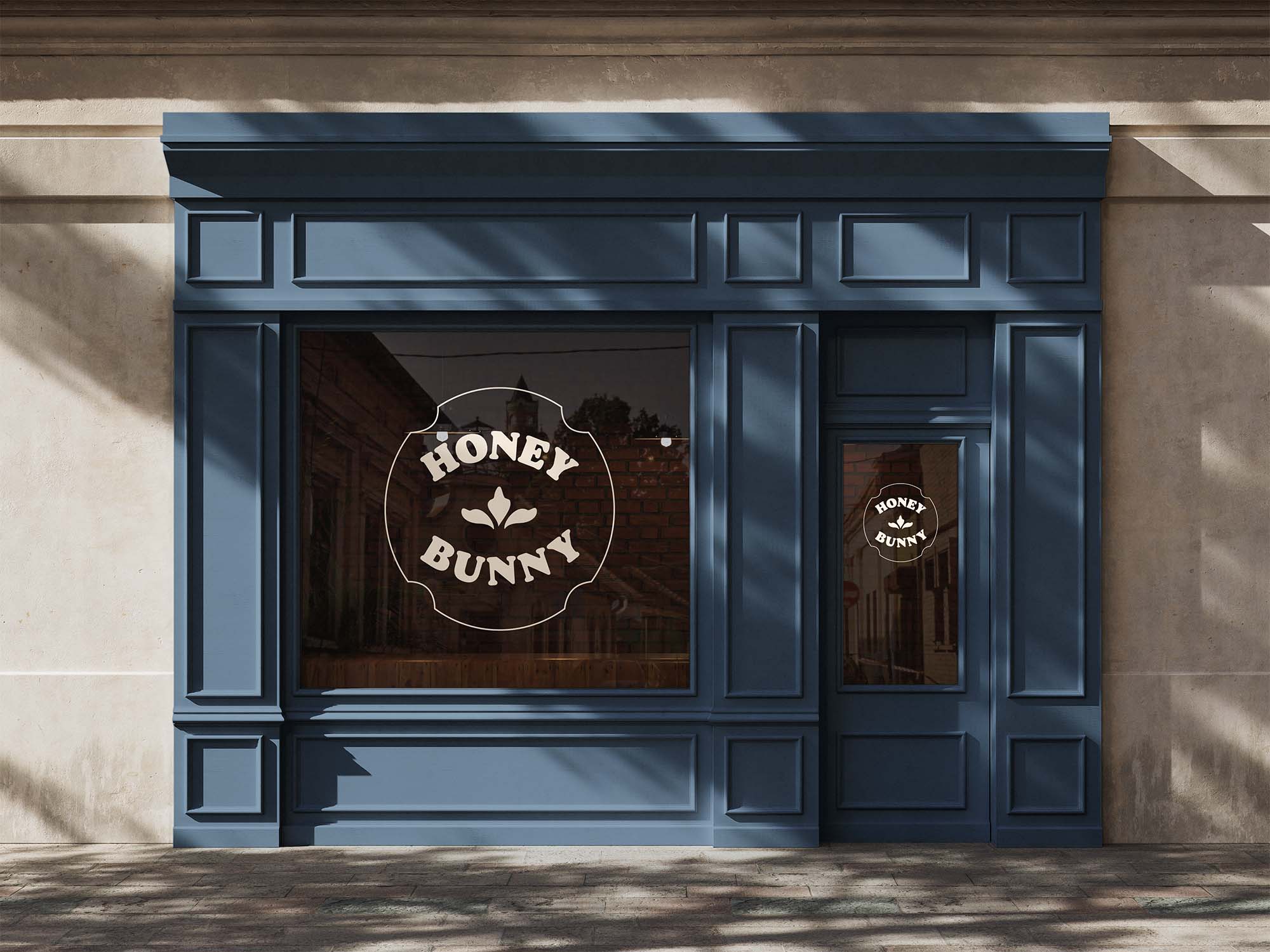 Blue storefront of a pastry shop with a window decal of the Honey Bunny Logo 